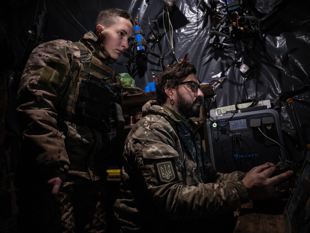 In this photo, taken Tuesday, Dec. 16, 2025 and provided by Ukraine's 93rd Kholodnyi Yar Separate Mechanized Brigade press service, soldiers control an FPV drone to fire towards Russian positions in a shelter in Kostyantynivka direction, Donetsk region, Ukraine. (Iryna Rybakova/Ukraine's 93rd Mechanized Brigade via AP)