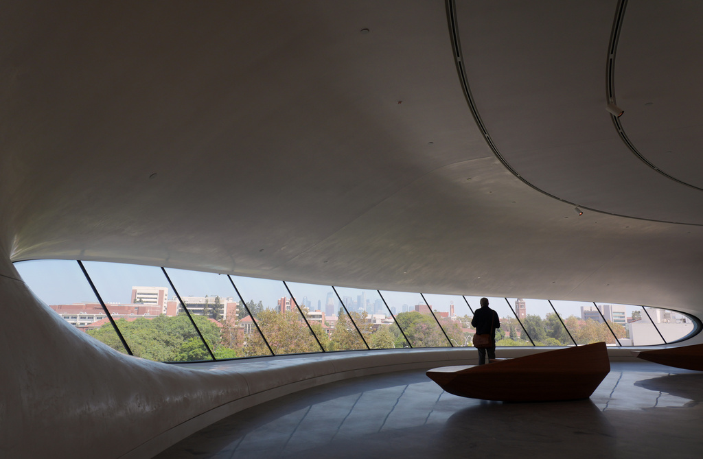 A visitor is silhouetted in front of windows looking out to downtown Los Angeles during a preview of the Lucas Museum of Narrative Art on Monday, Aug. 31, 2026, in Los Angeles. (AP Photo/Chris Pizzello)