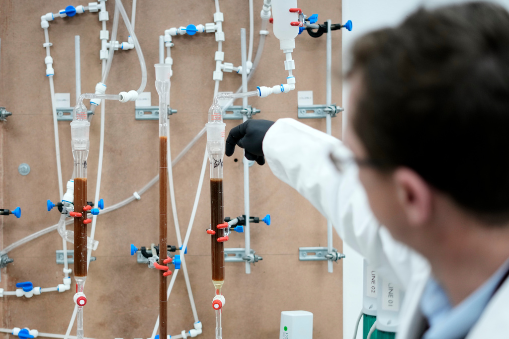 Metallurgist Roux Wildenboer explains how ion exchange test work is performed on a bench scale at a Rainbow Rare Earths laboratory in Johannesburg, South Africa, Thursday, Aug. 7, 2025. (AP Photo/Themba Hadebe)