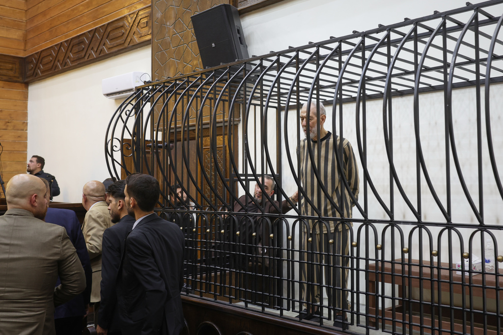 Syria's former grand mufti under ousted President Bashar Assad, Ahmad Badreddine Hassoun, stands as he listens a court sentence of life in prison at the Palace of Justice in Damascus, Syria, Monday, Aug. 24, 2026. (AP Photo/Ghaith Alsayed)
