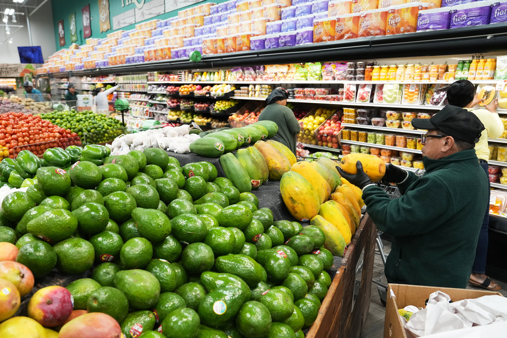 An employee stocks papayas at the Price Choice supermarket which participates in the USDA Supplemental Nutrition Assistance Program (SNAP), Friday, Nov. 14, 2025, in Miami. (AP Photo/Lynne Sladky)