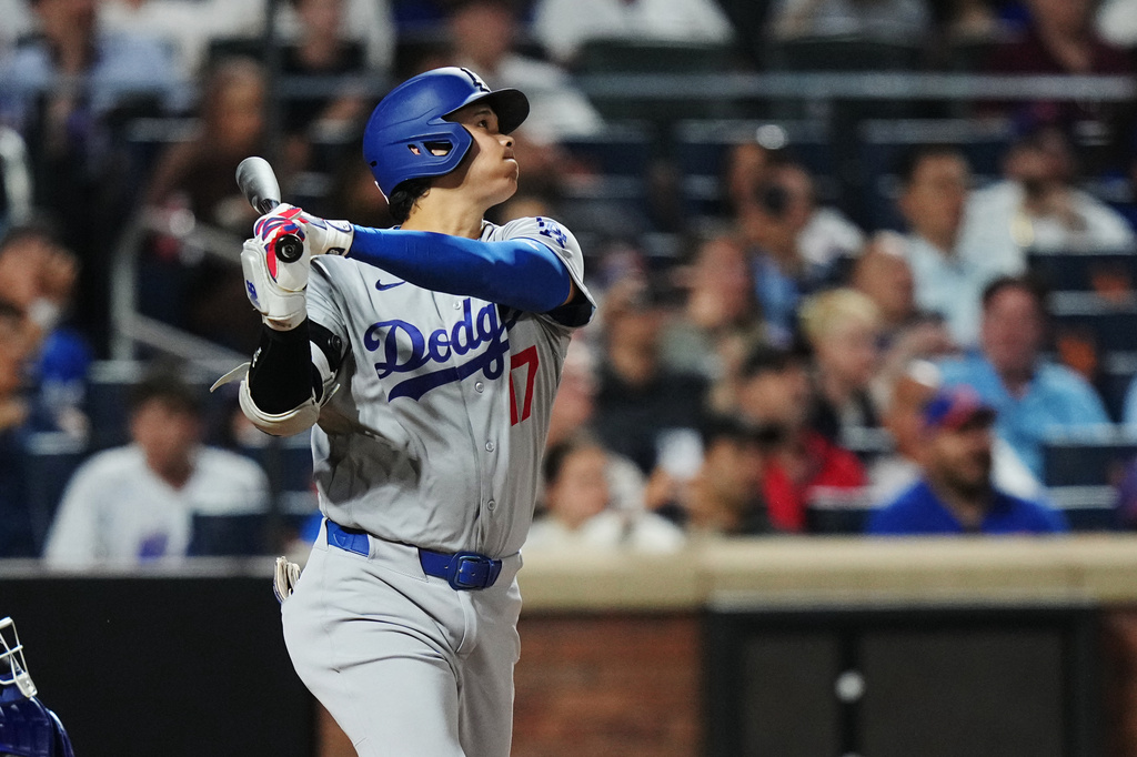 Los Angeles Dodgers' Shohei Ohtani follows through on a sacrifice fly ball to drive in a run during the seventh inning of a baseball game against the New York Mets Friday, July 24, 2026, in New York. (AP Photo/Frank Franklin II)