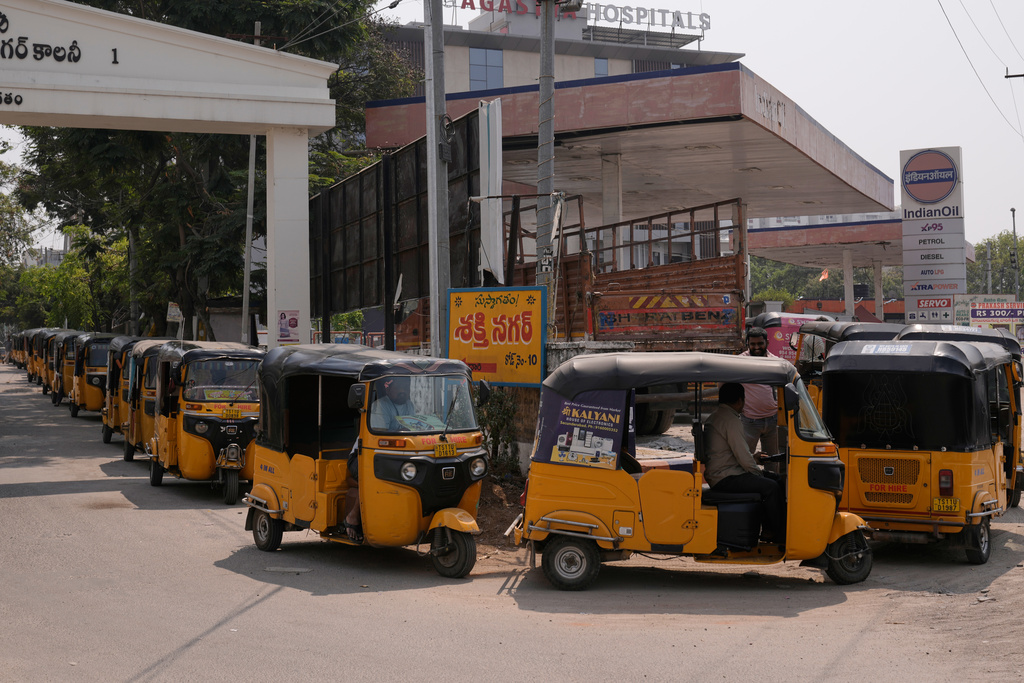 Auto rickshaw drivers queue to refuel their vehicles with CNG at a fuel station in Hyderabad, India, Saturday, March 14, 2026. (AP Photo/Mahesh Kumar A.)