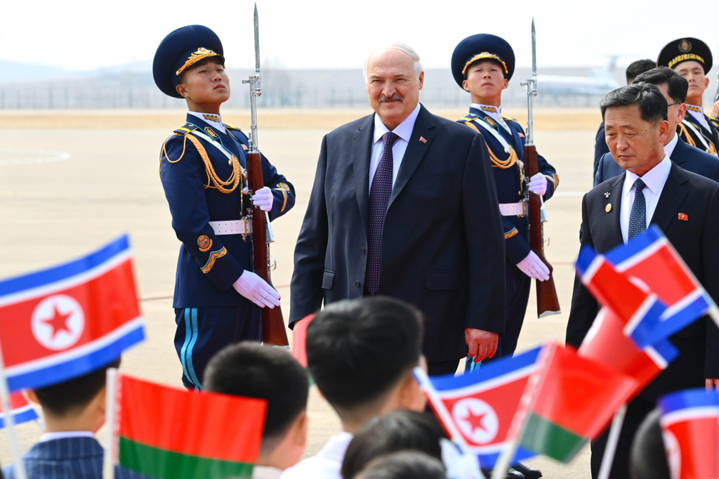In this photo released by Belarus' Presidential Press Service, Belarusian President Alexander Lukashenko, center, arrives to the Pyongyang International Airport, outside Pyongyang, North Korea, Wednesday, March 25, 2026. (Belarus' Presidential Press Service via AP)