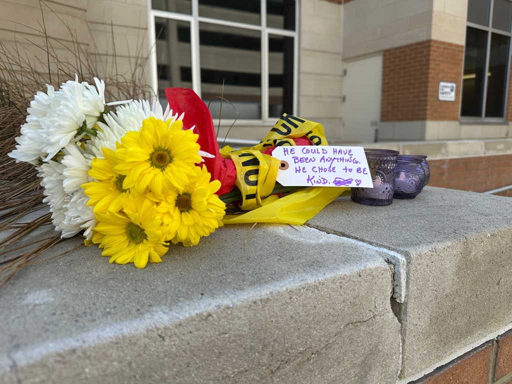 A bouquet of flowers with a note and votive candles sits at the entrance of Constant Hall at Old Dominion University in Norfolk, Va., on Friday, March 13, 2026. (AP Photo/Allen G. Breed)