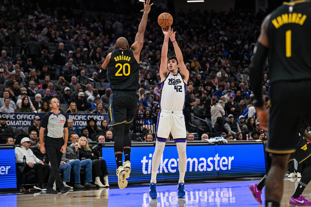 Sacramento Kings center Maxime Raynaud (42) attempts a shot over Golden State Warriors center Al Horford (20) during the first half of an NBA basketball game, Wednesday, Nov. 5, 2025, in Sacramento, Calif. (AP Photo/Justine Willard)