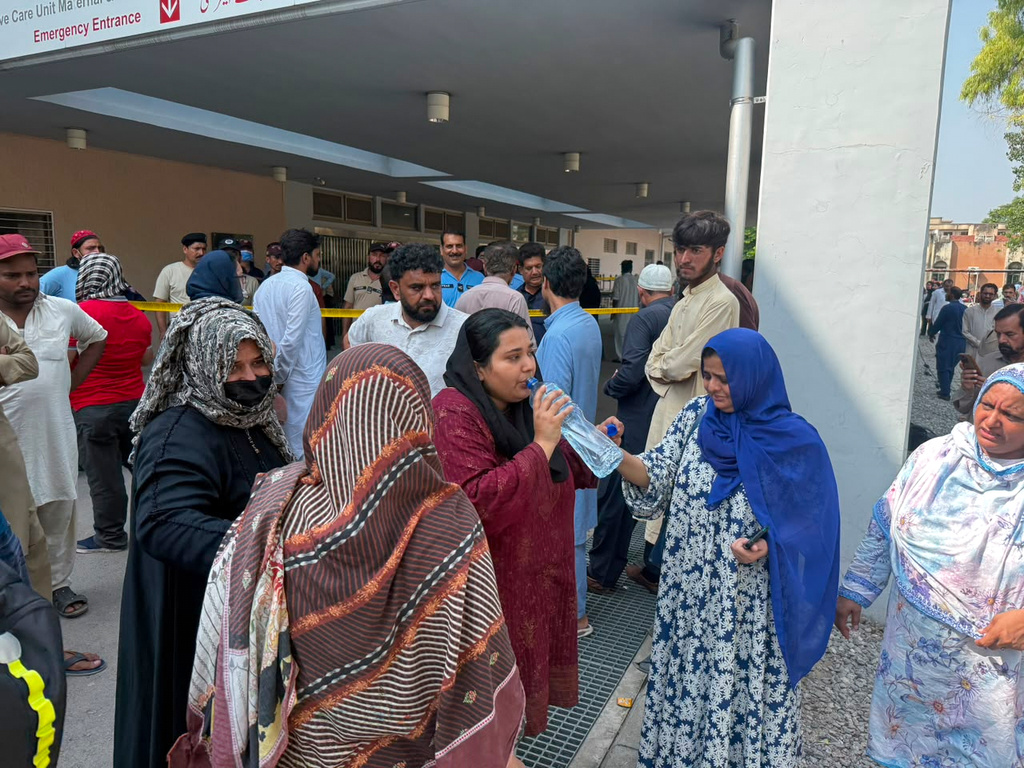 Relatives of the children who died in a hospital fire, gather at the hospital, in Islamabad, Pakistan, Wednesday, Aug. 26, 2026. (AP Photo/M.Yousaf)