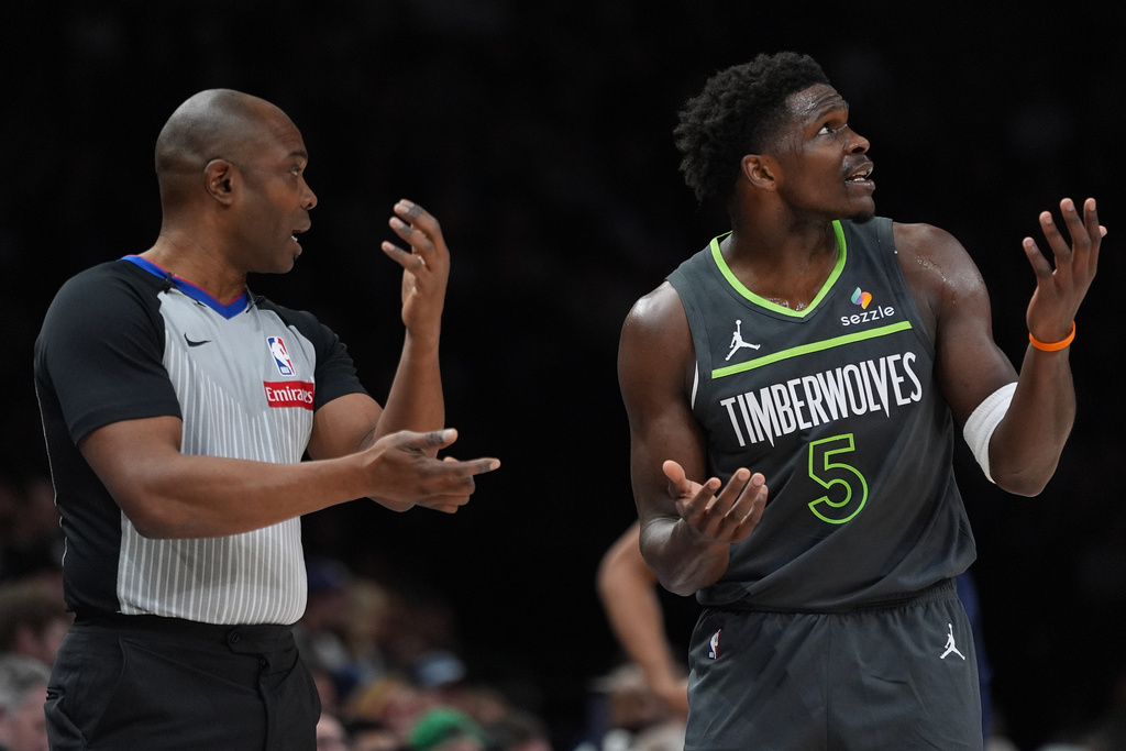 Minnesota Timberwolves guard Anthony Edwards (5) reacts next to referee Courtney Kirkland during the first half of an NBA basketball game against the San Antonio Spurs, Sunday, Jan. 11, 2026, in Minneapolis. (AP Photo/Abbie Parr)