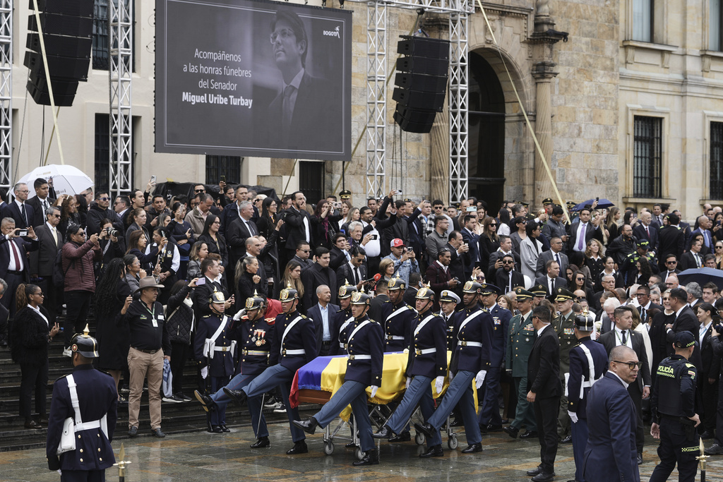 The coffin of presidential hopeful and opposition Sen. Miguel Uribe, who died of gunshot wounds sustained at a political rally, is carried to the cathedral in Bogota, Colombia, Wednesday, Aug. 13, 2025. (AP Photo/Ivan Valencia)