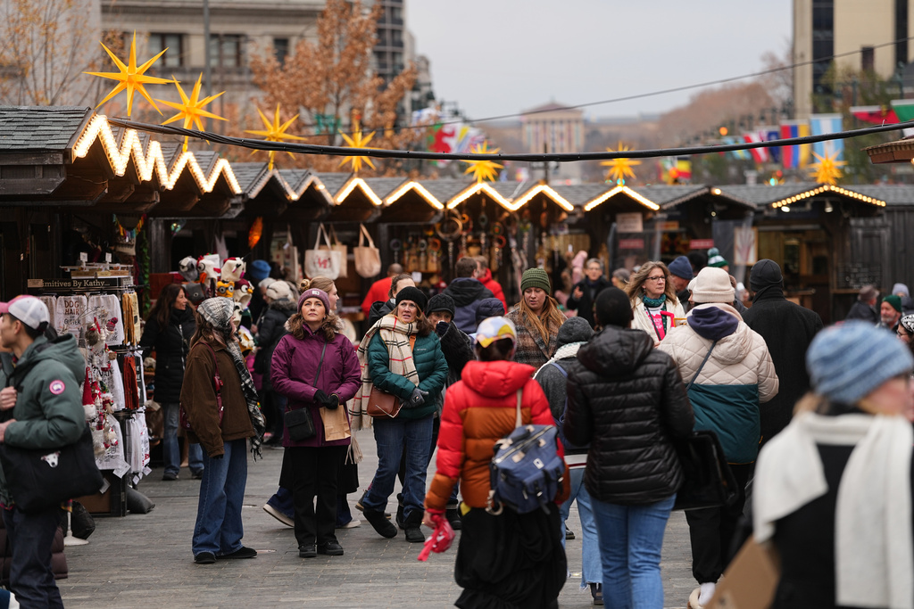 FILE - People shop at the Christmas Village in Philadelphia, in Philadelphia, Wednesday, Dec. 10, 2025. (AP Photo/Matt Rourke, File)