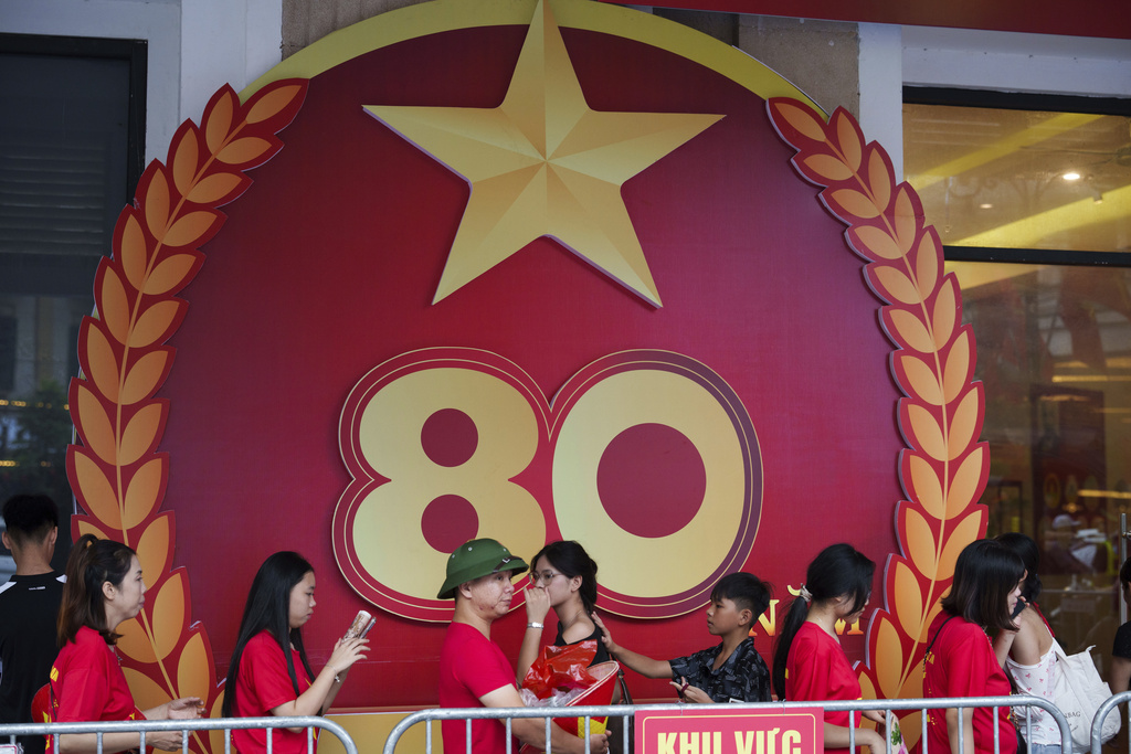 Pedestrian walks infront a billboard as the nation celebrating Vietnam's 80th National Day in Hanoi, Friday, Aug. 29, 2025. (AP Photo/Vincent Thian)