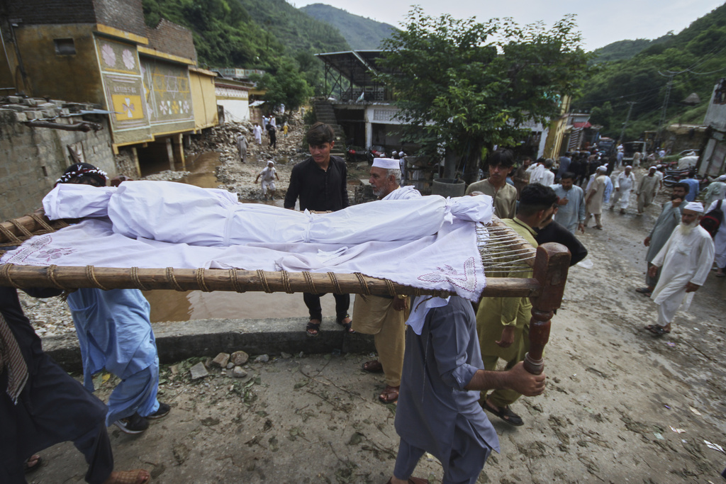 Local residents carry a body of child for funeral prayer, which was recovered from the rubble of a damaged home following Monday's flash flooding due to heavy rains, in Dalori village in Swabi, a district of Pakistan's Khyber Pakhtunkhwa province, Tuesday, Aug. 19, 2025. (AP Photo/Muhammad Zubair)