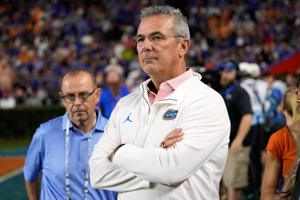 FILE - Former Florida head coach Urban Meyer watches the first half of an NCAA college football game between Florida and Tennessee, Saturday, Nov. 22, 2025, in Gainesville, Fla. (AP Photo/John Raoux, File)