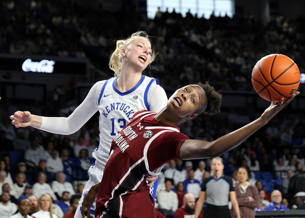 South Carolina's Joyce Edwards, right, stretches for a rebound next to Kentucky's Clara Strack (13) during an NCAA college basketball game in Lexington, Ky., Sunday, March 1, 2026. (AP Photo/James Crisp)