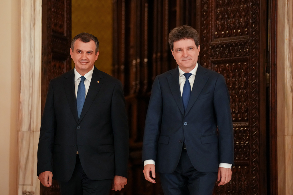 Romanian President Nicusor Dan, right, and Prime Minister designate Eugen Tomac arrive for press statements at the Cotroceni Presidential Palace in Bucharest, Romania, Thursday, June 4, 2026. (AP Photo/Vadim Ghirda)