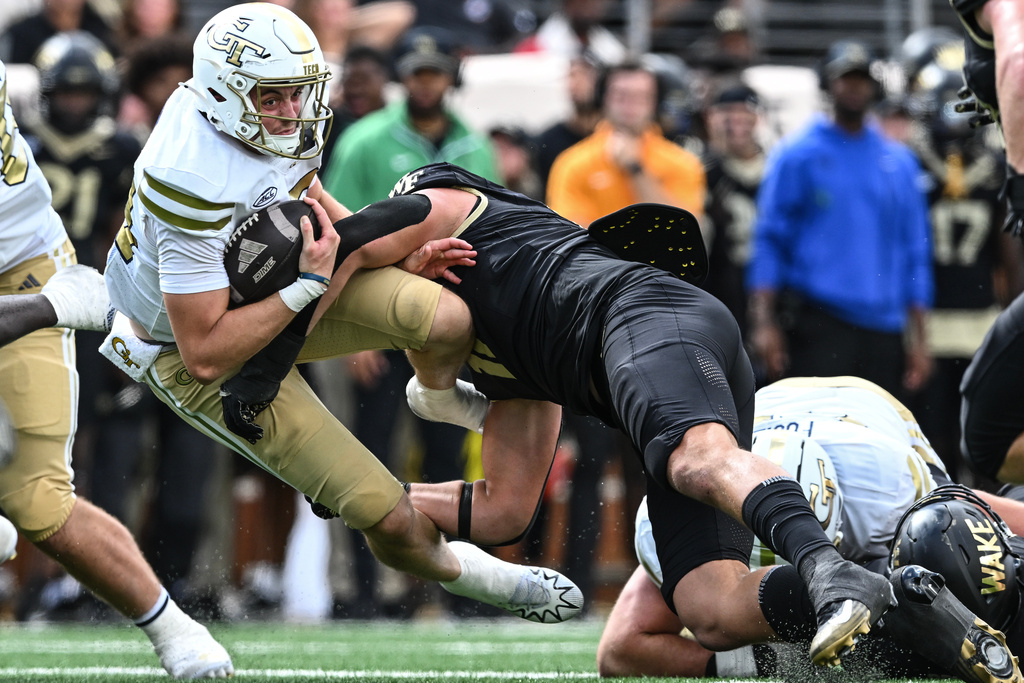 Georgia Tech quarterback Haynes King (10) is tackled by Wake Forest defensive lineman Gabe Kirschke (10) during the second half of an NCAA college football game, Saturday, Sept. 27, 2025, in Winston-Salem, N.C. (AP Photo/Matt Kelley)