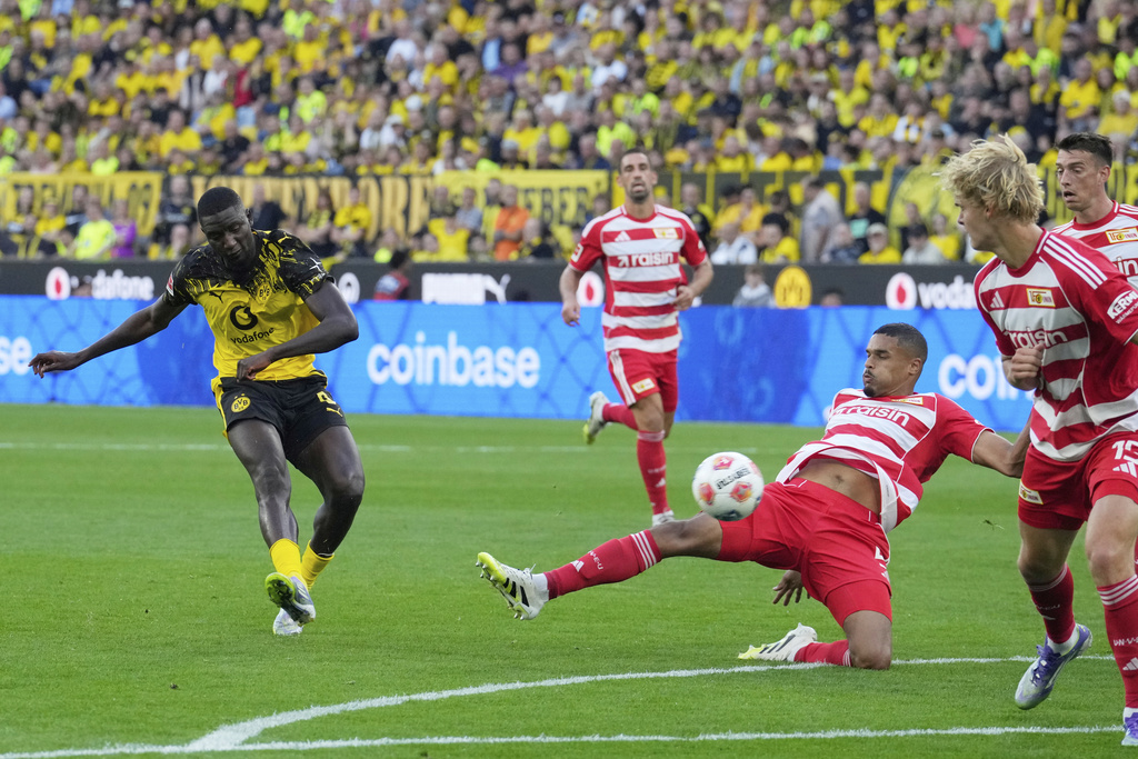 Dortmund's Serhou Guirassy, left, kicks the ball during the German Bundesliga soccer match between Borussia Dortmund and Union Berlin at the Signal-Iduna Park in Dortmund, Germany, Sunday, Aug. 31, 2025. (AP Photo/Martin Meissner)