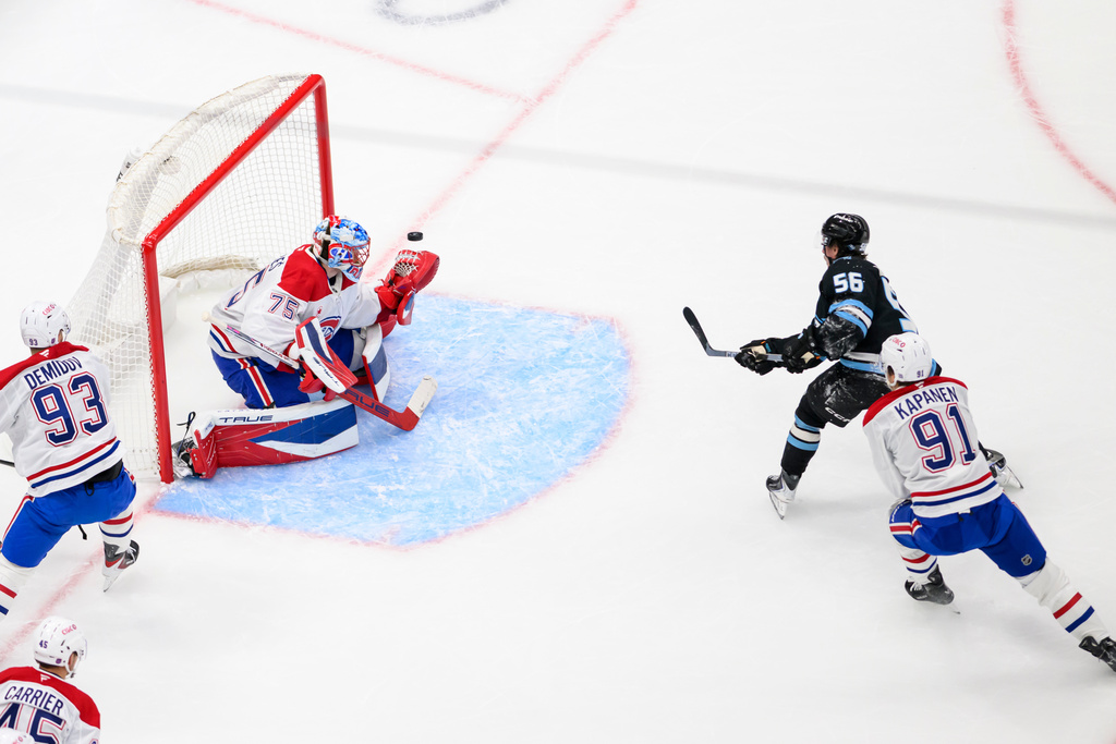 Utah Mammoth right wing Kailer Yamamoto (56) shoots the puck past Montréal Canadiens goaltender Jakub Dobes (75) for a goal during the second period of an NHL hockey game, Wednesday, Nov. 26, 2025, in Salt Lake City. (AP Photo/Tyler Tate)