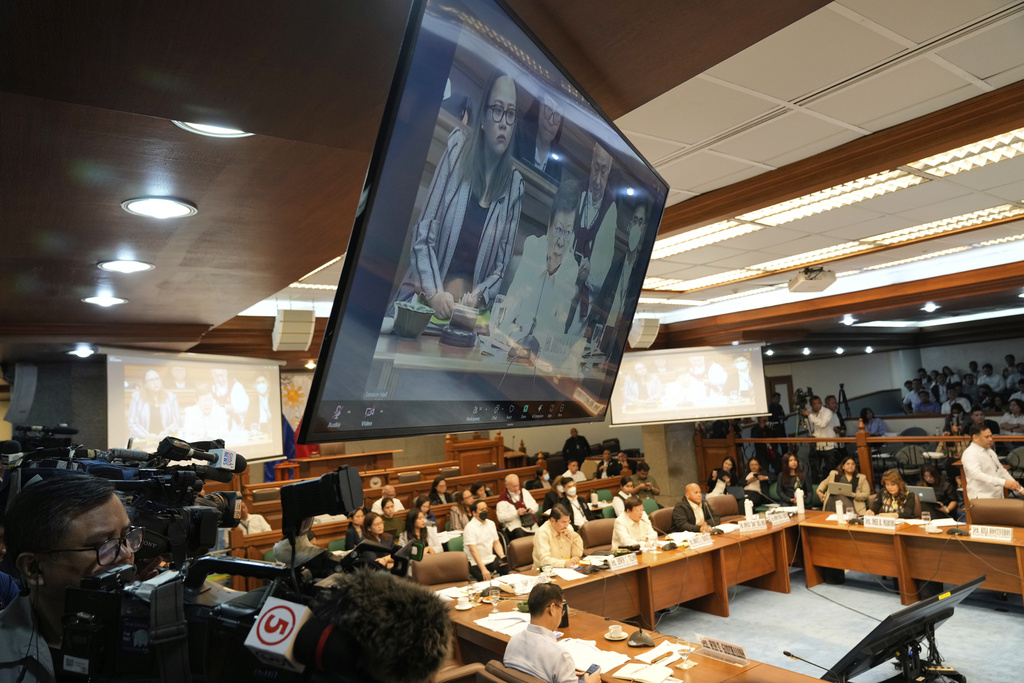 Senator Rodante Marcoleta is shown on electronic screens during investigations on flood-control projects at the Senate Blue Ribbon committee in Pasay city, Philippines on Monday, Sept. 8, 2025. (AP Photo/Aaron Favila)