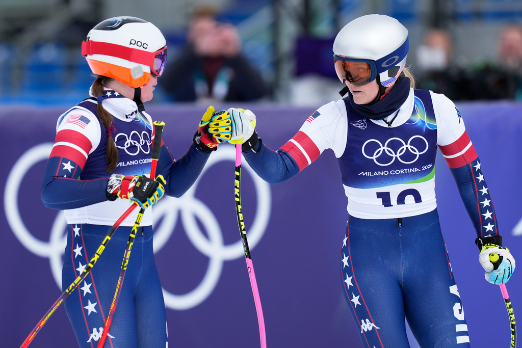 United States' Lindsey Vonn, right, and Breezy Johnson at the finish area during an alpine ski, women's downhill official training, at the 2026 Winter Olympics, in Cortina d'Ampezzo, Italy, Friday, Feb. 6, 2026. (AP Photo/Giovanni Auletta)