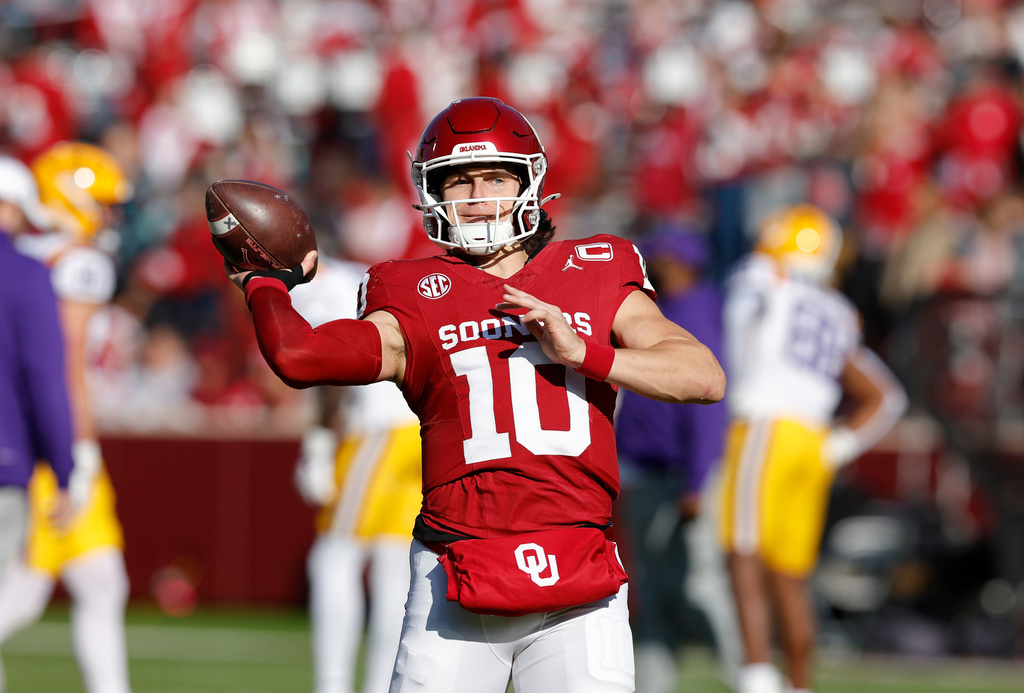 Oklahoma quarterback John Mateer (10) warms up before the start of an NCAA college football game against LSU Saturday, Nov. 29, 2025, in Norman, Okla. (AP Photo/Alonzo Adams)