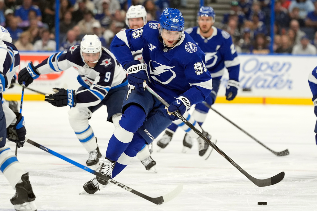 Tampa Bay Lightning right wing Ilya Mikheyev (95) breaks out ahead of Winnipeg Jets left wing Alex Iafallo (9) during the second period of an NHL hockey game Thursday, Oct. 29, 2026, in Tampa, Fla. (AP Photo/Chris O'Meara)