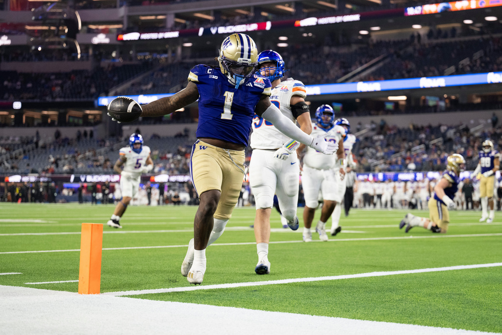 Washington running back Jonah Coleman (1) runs with the ball to score a touchdown during the second half of the LA Bowl NCAA college football game against Boise State Saturday, Dec. 13, 2025, in Inglewood, Calif. (AP Photo/Kyusung Gong)