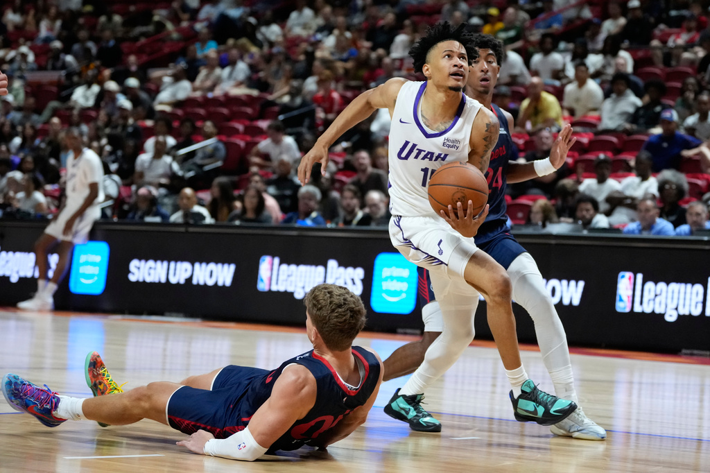 Utah Jazz's Trey Alexander drives against LA Clippers' Sean Pedulla during the second half of an NBA Summer League basketball game Sunday, July 12, 2026, in Las Vegas. (AP Photo/John Locher)