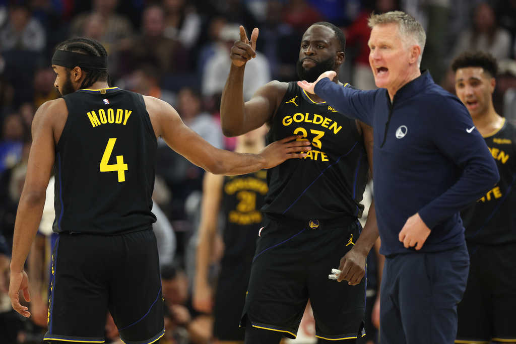 Golden State Warriors forward Draymond Green (23) gestures toward a referee after being ejected as Moses Moody (4) restrains him during the first half of an NBA basketball game against the Phoenix Suns in San Francisco, Saturday, Dec. 20, 2025. (AP Photo/Jed Jacobsohn)