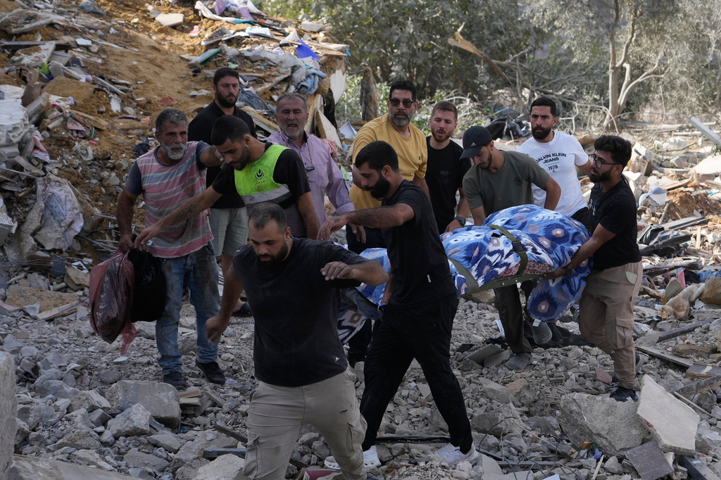 People carry a body of a person who was killed at a house that was hit by an Israeli airstrike in Arab Salim village, southern Lebanon, Sunday, Sept. 6, 2026. (AP Photo/Mohammed Zaatari)