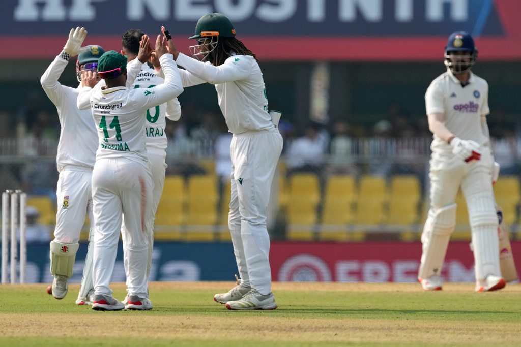 South Africa's players celebrate the dismissal of India's KL Rahul, right, on the third day of the second cricket test match between India and South Africa in Guwahati, India, Saturday, Nov. 22, 2025. (AP Photo/Anupam Nath)