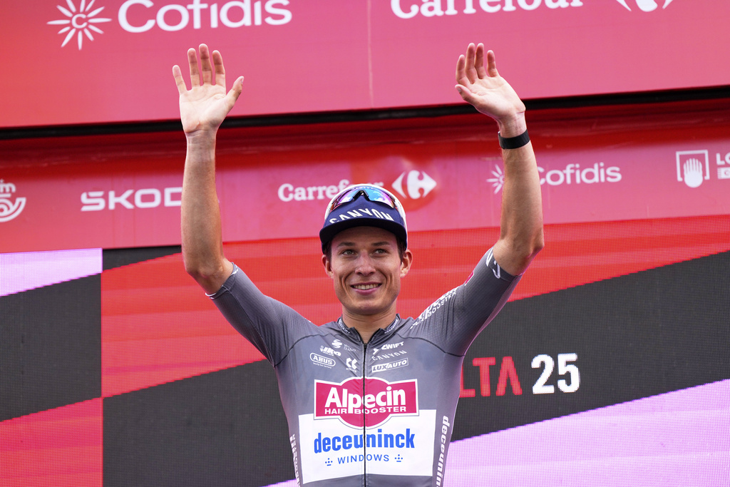 Belgian cyclist Jasper Philipsen celebrates at the podium after wining the nineteenth stage of the Spanish La Vuelta cycling race, from Rueda to Guijuelo, Spain, Friday, Sept. 12, 2025. (AP Photo/Manu Fernandez)