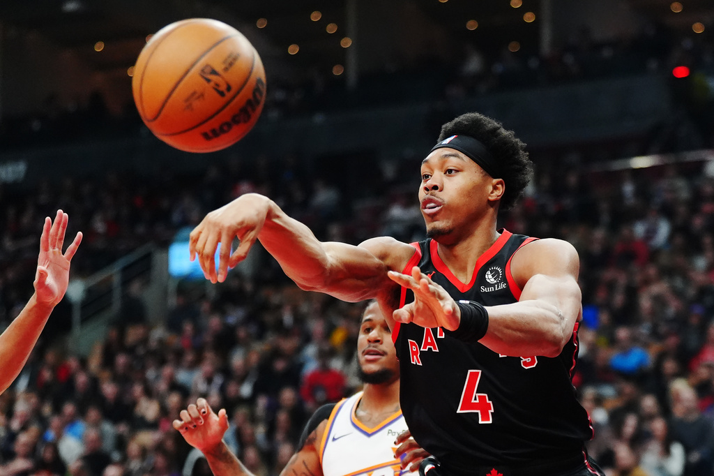Toronto Raptors' Scottie Barnes (4) passes the ball against the Phoenix Suns during first-half NBA basketball game action in Toronto, Friday, March 13, 2026. (Frank Gunn/The Canadian Press via AP)