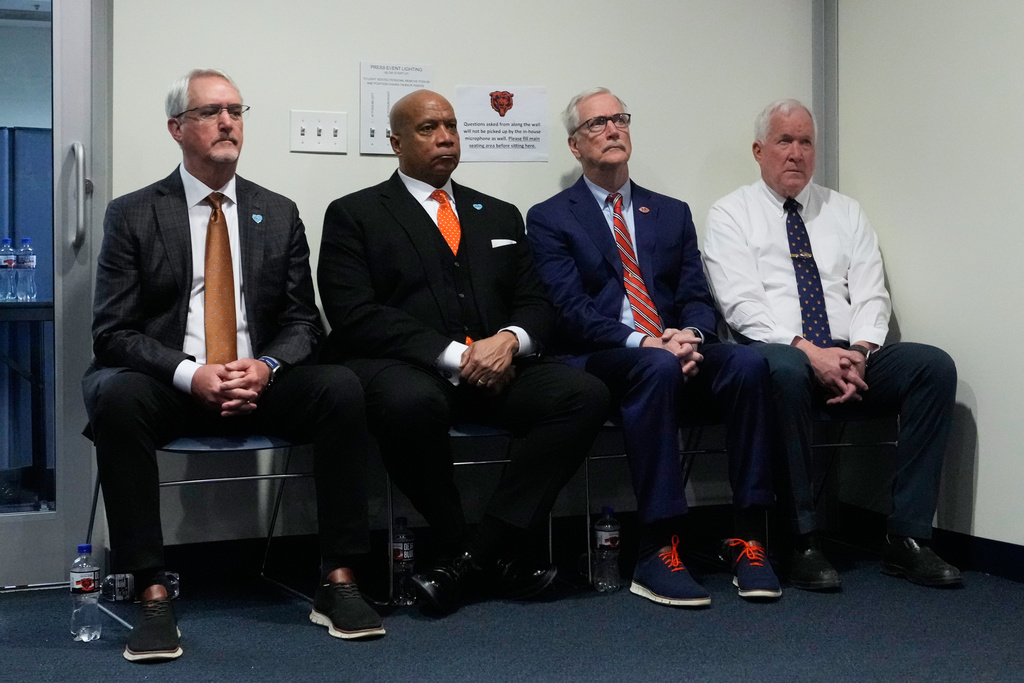 Chicago Bears owners Brian McCaskey, left, George McCaskey, second from right, Patrick McCaskey, right, and Chicago Bears President and CEO Kevin Warren, second from left, listen to general manager Ryan Poles at a news conference in Lake Forest, Ill., Wednesday, Jan. 21, 2026. (AP Photo/Nam Y. Huh)