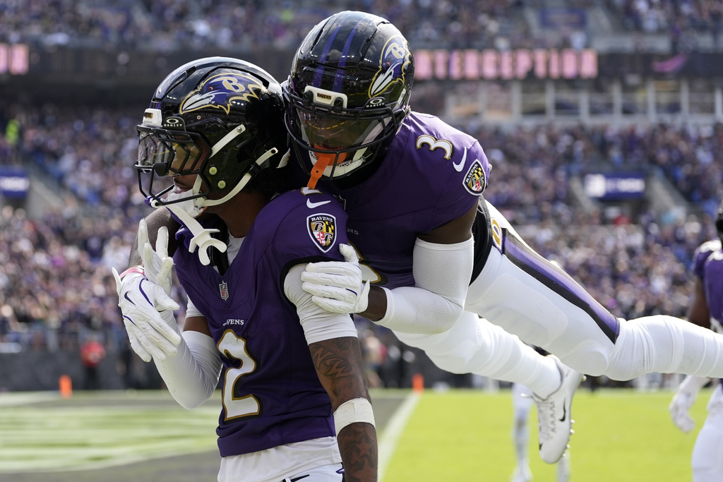 Baltimore Ravens cornerback Nate Wiggins, left, celebrates after an interception with cornerback Chidobe Awuzie during the second half of an NFL football game against the Cleveland Browns, Sunday, Sept. 14, 2025, in Baltimore. (AP Photo/Stephanie Scarbrough)