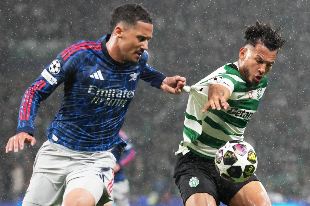 Arsenal's William Saliba, left, challenges Sporting's Luis Suarez during the Champions League quarterfinals, first leg, soccer match between Sporting CP and Arsenal, in Lisbon, Tuesday, April 7, 2026. (AP Photo/Armando Franca)