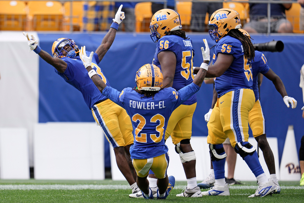 Pittsburgh wide receiver Cataurus Hicks, left, celebrates with teammates after scoring a touchdown during the first half of an NCAA college football game against Louisville in Pittsburgh Saturday, Sept. 27, 2025. (AP Photo/Gene J. Puskar)