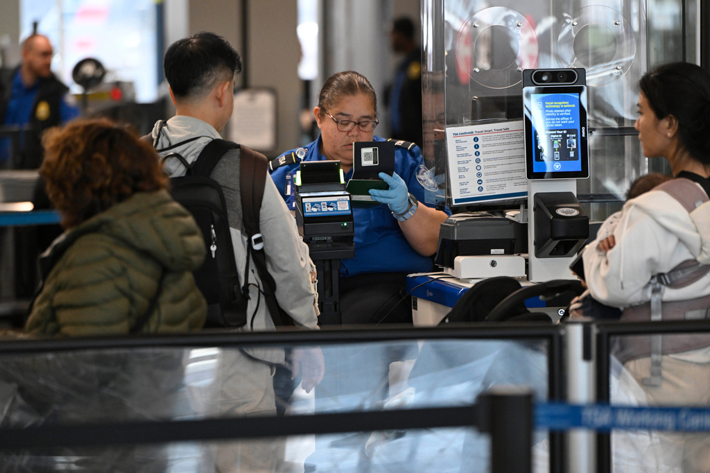 Passengers are screened by a TSA agent at O'Hare Airport in Chicago, Thursday, March 26, 2026. (AP Photo/Paul Beaty)