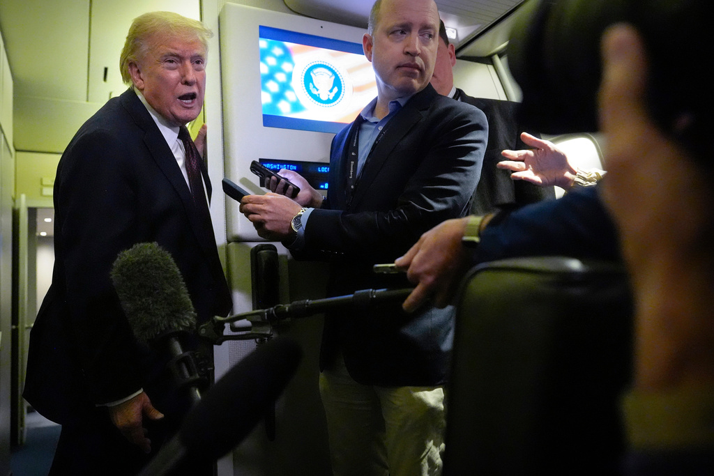 President Donald Trump speaks to reporters aboard Air Force One, Sunday, March 15, 2026, en route from West Palm Beach, Fla. to Joint Base Andrews, Md. (AP Photo/Mark Schiefelbein)