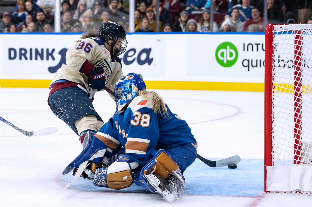 Montreal Victoire's Natalie Mlynkova (96) scores on Vancouver Goldeneyes goaltender Emerance Maschmeyer (38) during the second period of a PWHL hockey game in Vancouver, British Columbia, Saturday, Dec. 20, 2025. (Ethan Cairns/The Canadian Press via AP)