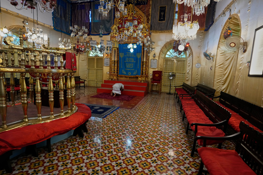 An Indian man prostrates himself in a traditional Hindu gesture of obeisance to the Torah ark during his visit to the 12th-century Kadavumbagam Synagogue in Ernakulam, mainland district of Kochi, India, Thursday, May 21, 2026. (AP Photo/Aijaz Rahi)