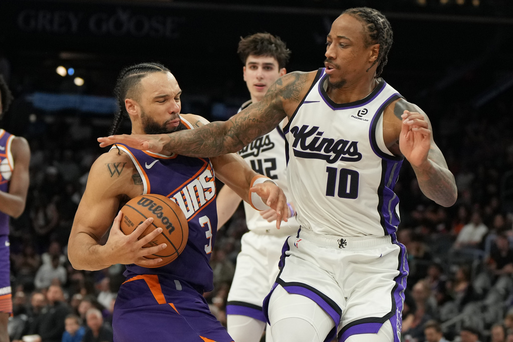 Sacramento Kings guard Demar Derozan (10) fouls Phoenix Suns forward Dillon Brooks (3) during the second half of an NBA basketball game, Friday, Jan. 2, 2026, in Phoenix. (AP Photo/Rick Scuteri)