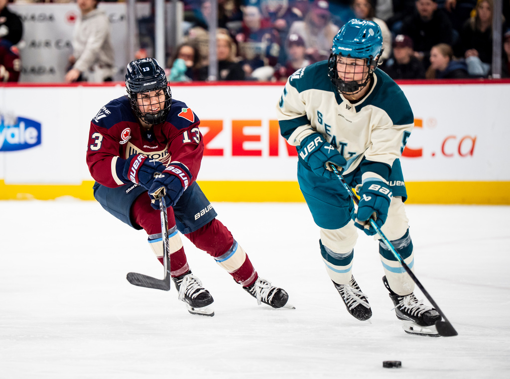 Montreal Victoire's Alexandra Labelle (13) defends against Seattle Torrent's Anna Wilgren (5) during the second period of a PWHL hockey gamen in Laval, Que., on Tuesday, April 7, 2026. (Christopher Katsarov/The Canadian Press via AP)