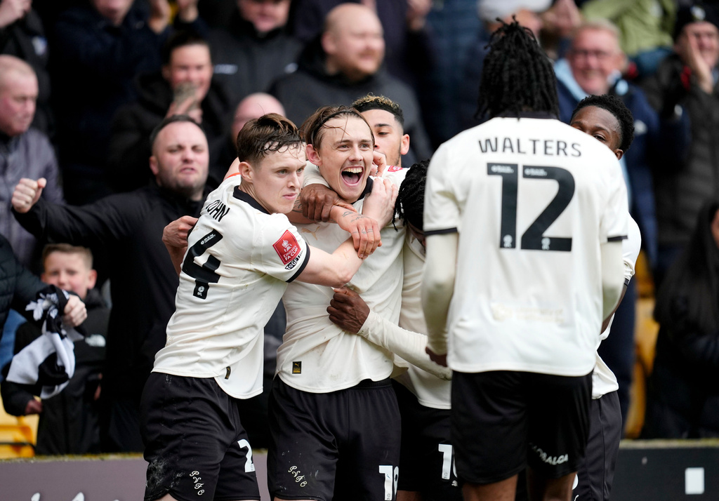 Port Vale's Ben Waine celebrates with teammates after scoring his side's first goal of the game, during the FA Cup fifth round soccer match between Sunderland and Port Vale, in Stoke on Trent, England, Sunday March 8, 2026. (Nick Potts/PA via AP)