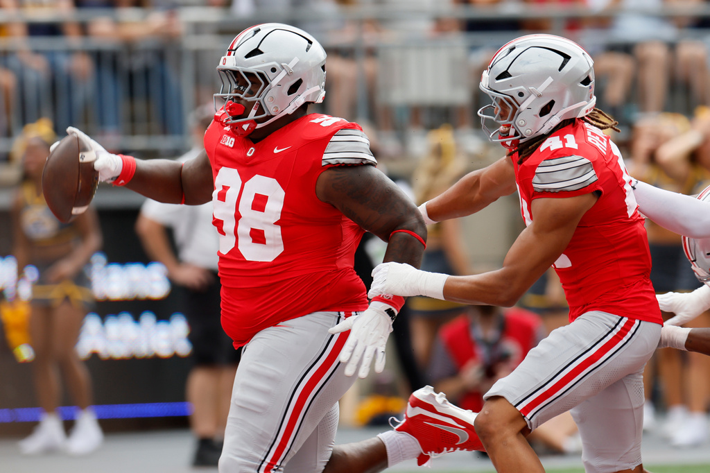 Ohio State defensive lineman Jamir Perez, left, scores a touchdown after recovering a fumble against Kent State during the second half of an NCAA college football game, Saturday, Sept. 19, 2026, in Columbus, Ohio. (AP Photo/Jay LaPrete)