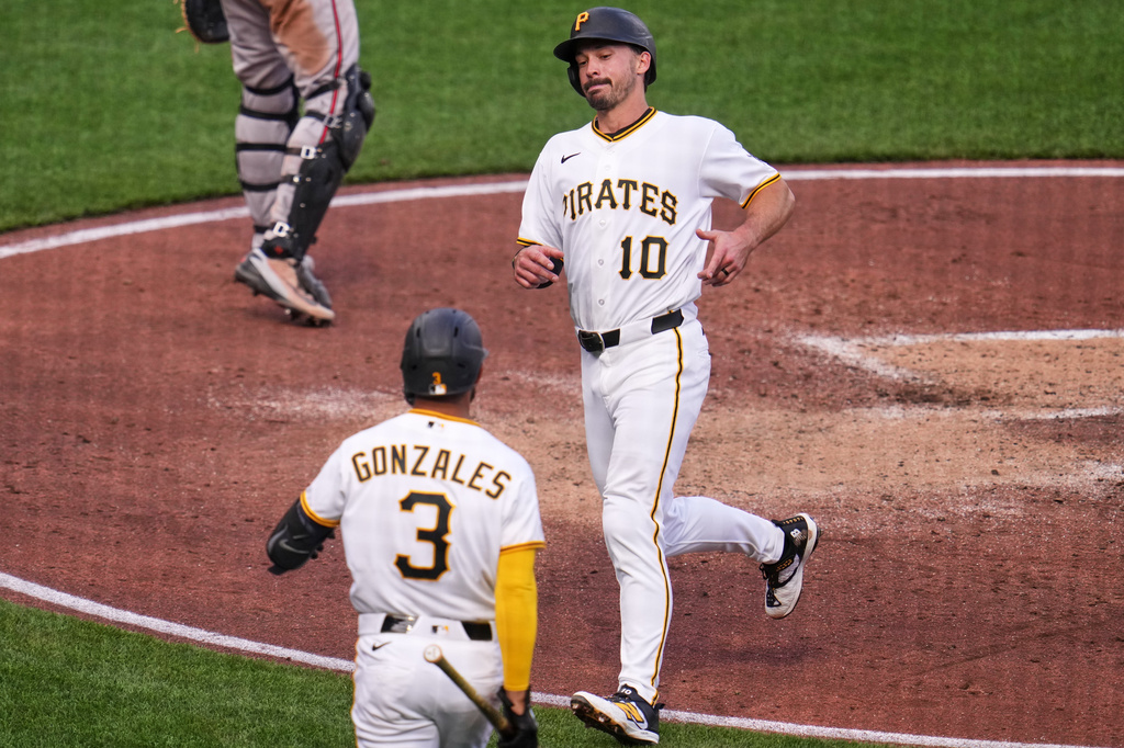 Pittsburgh Pirates' Bryan Reynolds (10) scores on a sacrifice fly hit by Pittsburgh Pirates' Spencer Horwitz off Baltimore Orioles pitcher Shane Baz during the fourth inning of a baseball game in Pittsburgh, Saturday, April 4, 2026. (AP Photo/Gene J. Puskar)