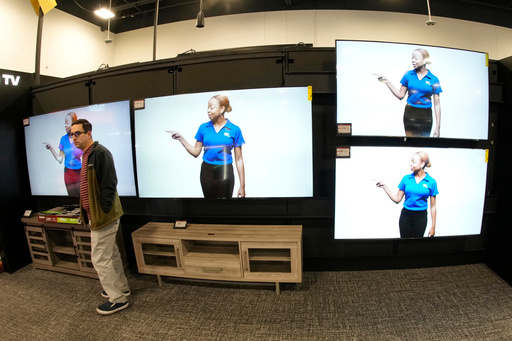 FILE - A customer turns away after looking at big-screen televisions on display in a Best Buy store, Nov. 21, 2023, in southeast Denver. (AP Photo/David Zalubowski, file) FILE - A customer turns away after looking at big-screen televisions on display in a Best Buy store, Nov. 21, 2023, in southeast Denver. (AP Photo/David Zalubowski, file)