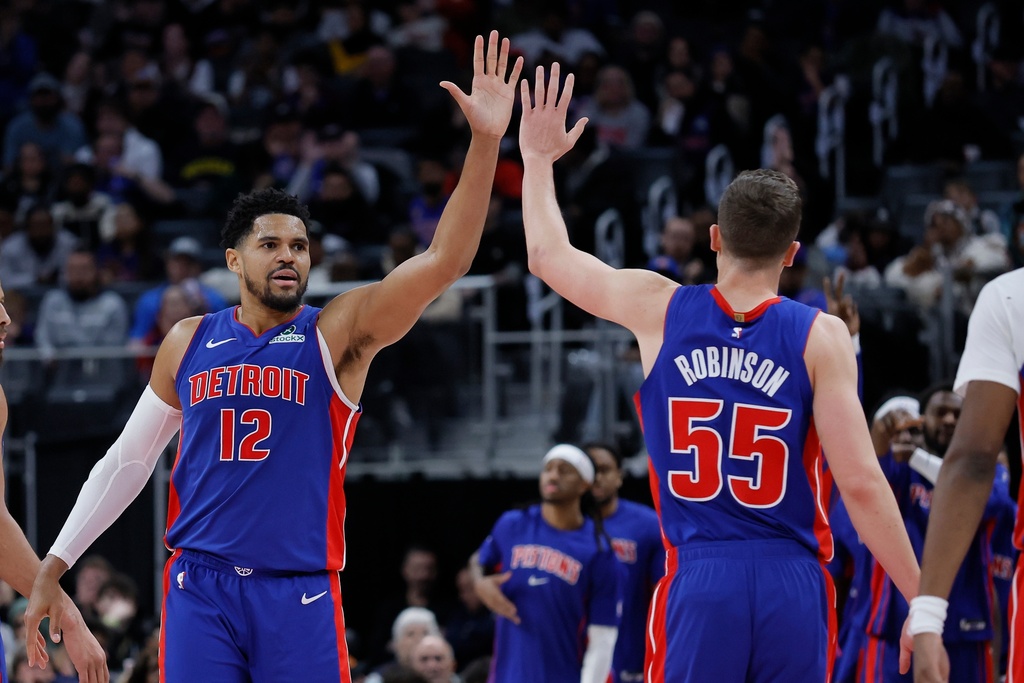 Detroit Pistons forward Tobias Harris (12) celebrates with forward Duncan Robinson (55) during the second half of an NBA basketball game against the Sacramento Kings, Sunday, Jan. 25, 2026, in Detroit. (AP Photo/Duane Burleson)