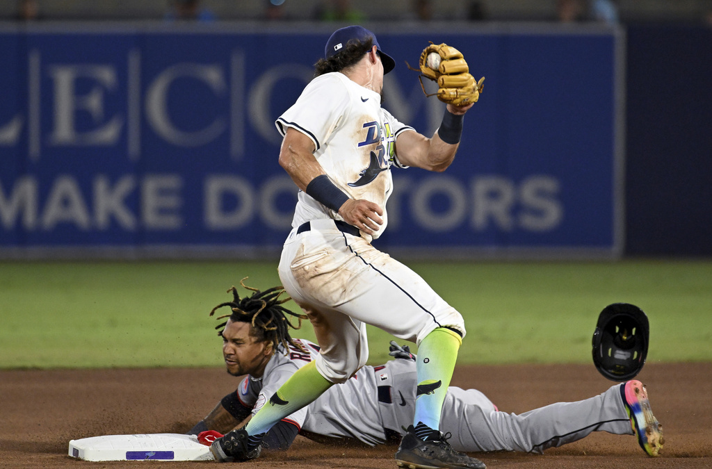 Cleveland Guardians' José Ramírez, bottom, steals second base before a tag by Tampa Bay Rays shortstop Tristan Gray, top, during the fourth inning of a baseball game Saturday, Sept. 6, 2025, in Tampa, Fla. (AP Photo/Jason Behnken)