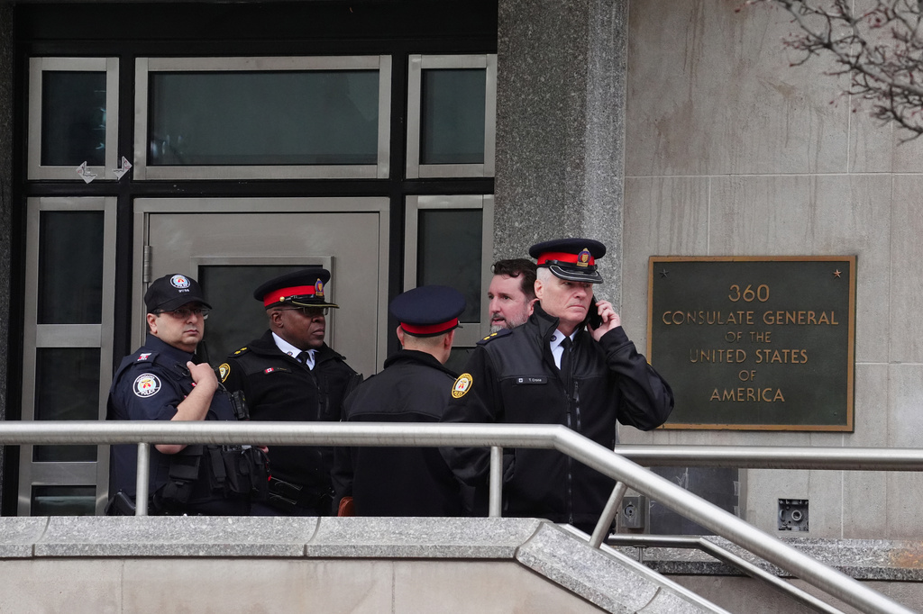 FILE - Toronto police officers investigate outside the U.S. consulate in Toronto on March 10, 2026. (Frank Gunn/The Canadian Press via AP, File)